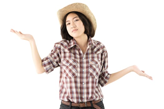 Young pretty woman in a cowboy hat and plaid shirt posing in studio with isolated on white background