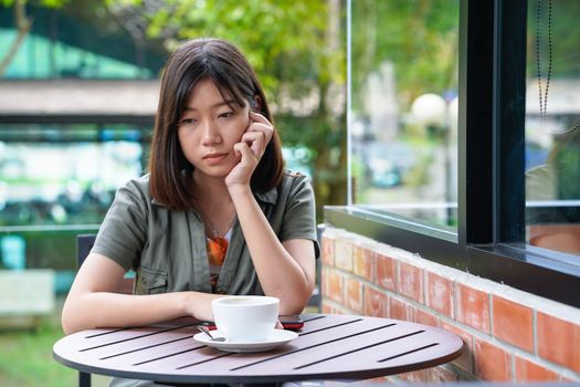 Pretty woman sitting in a cafe terrace with coffee cup