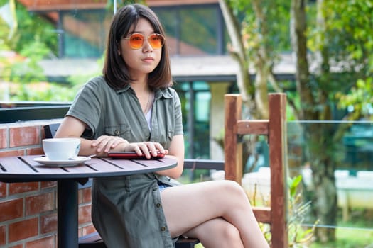 Pretty woman sitting in a cafe terrace with coffee cup