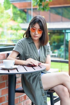 Pretty woman sitting in a cafe terrace with coffee cup