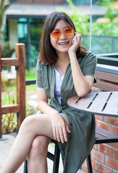 Pretty woman sitting in a cafe terrace use smartphone