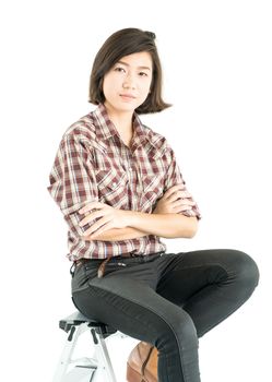 Young pretty woman in plaid shirt posing in studio with isolated on white background