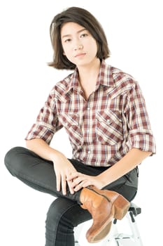 Young pretty woman in plaid shirt posing in studio with isolated on white background