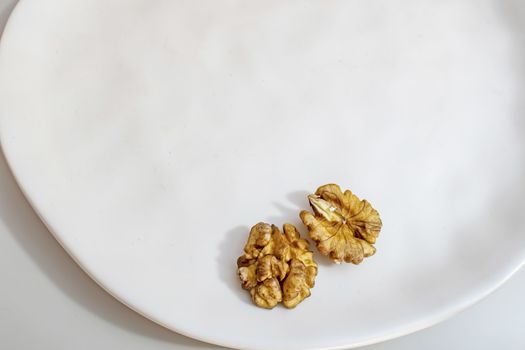 unshelled walnuts on a white plate