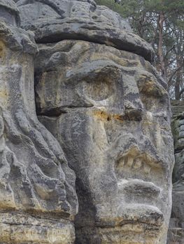 big face devils head sculpted in 1846 by Vaclav Levy to the sand stone rock in Zelizy, czech republic