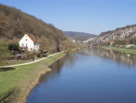 view on river Berounka from pedestrial bridge in village Srbsko in central Bohemian region on on spring sunny day, blue sky.