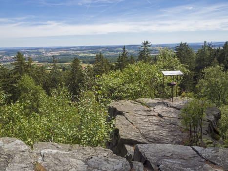 Viewpoint in Brdy mountain hills, with green trees, rocks town and blue sky, Czech Republic.
