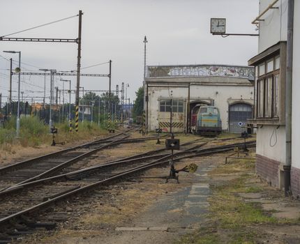 old rusty railway station with train depot and rail tracks