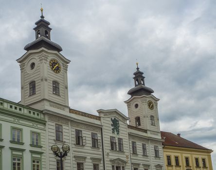 front of town hall palace with two towers  with clock in city Hradec Kralove in Czech republic