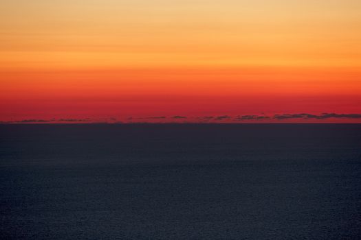 A beautiful sunset over calm Mediterranean waters at Dingli Cliffs in Malta