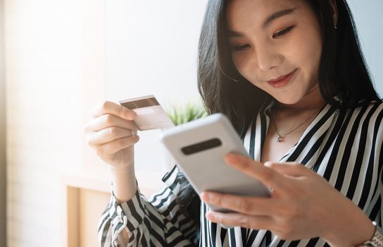 close up woman using smartphone and credit card for pay online shopping e-commerce online payment concept