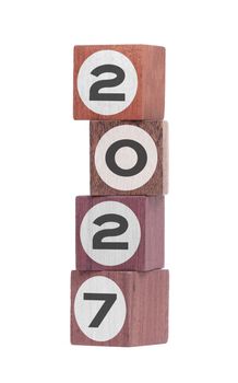 Four isolated hardwood toy blocks on white, saying 2027