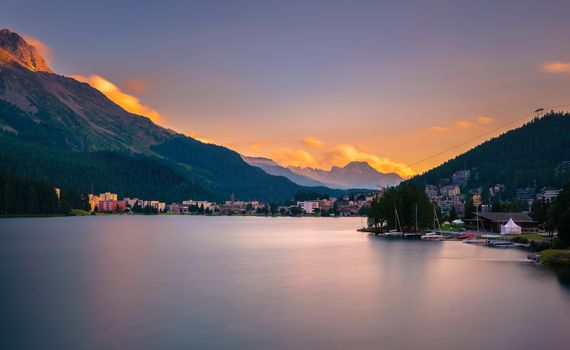 Sunset above St. Moritz with lake also called St. Moritzsee and Swiss Alps in the background in Engadin, Switzerland. Long exposure.