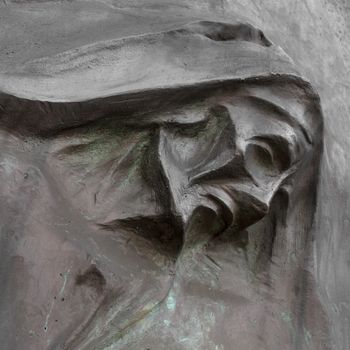 Stone portrait of Grim the Reaper (Death Taker or Angel of the Death). Halloween concept. Halloween sculpture.