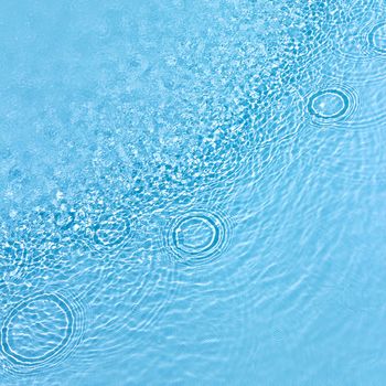 Water surface in the pool with raindrops