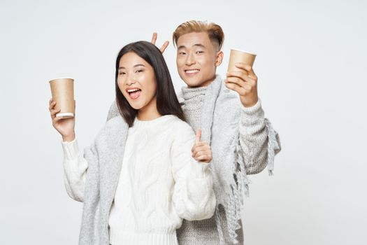 A cheerful young couple of Asian appearance elegant style glass with a lifestyle drink