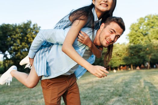 Cheerful young couple on nature walk the park fresh air