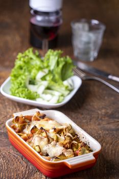 gratinated pasta on dark wood