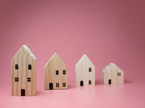 Mini residential craft house on a pink background.