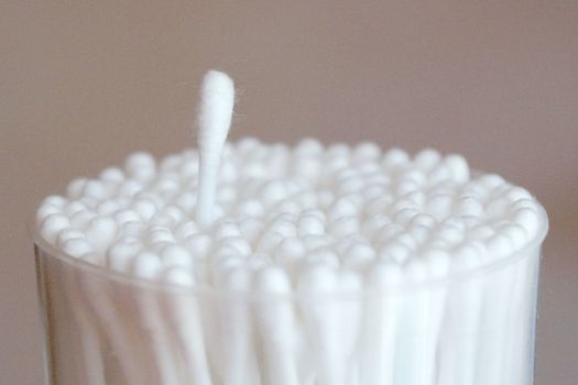 even packing of cotton swabs with one extended stick close-up