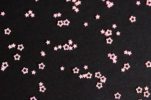 pink stars on black background close-up