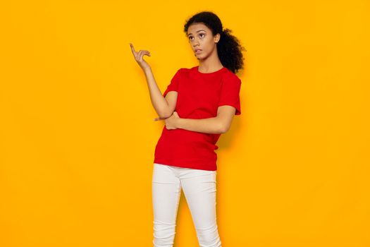 Beautiful woman emotions lifestyle elegant style red t-shirt attractive look lifestyle yellow background