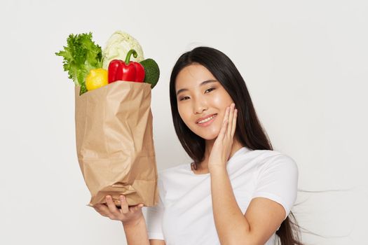 A beautiful woman of Asian appearance is a healthy food package Shopping housewife