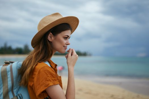 Beautiful woman tourist backpack hat travel walk landscape tropics island fresh air landscape