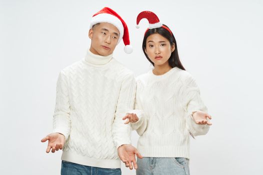 Loving man and woman in holiday hats celebrate Christmas