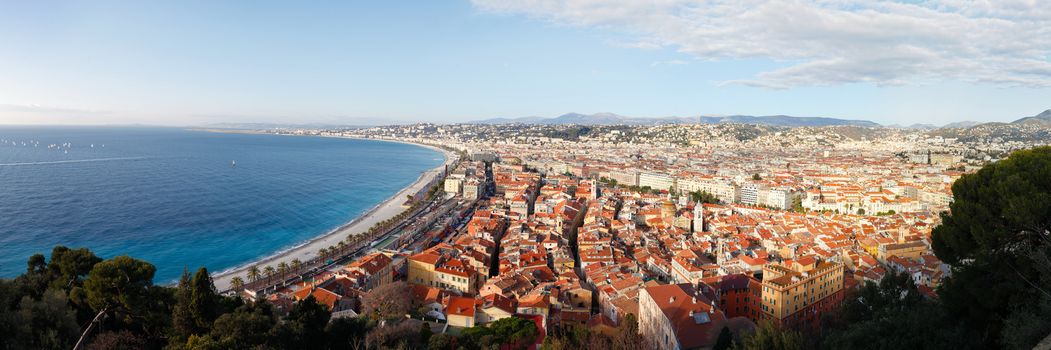 High resolution panorama of mediterranean sea and city of Nice with its red roofs and sky with clouds in background on December day. Nice, France