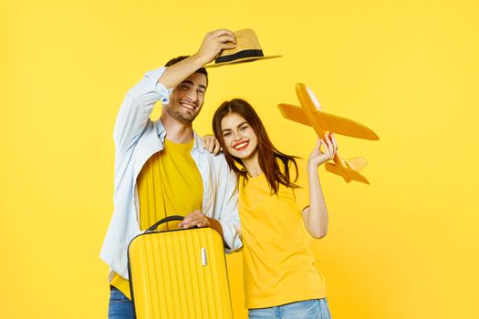 Loving couple at the airport with a toy airplane go on a trip