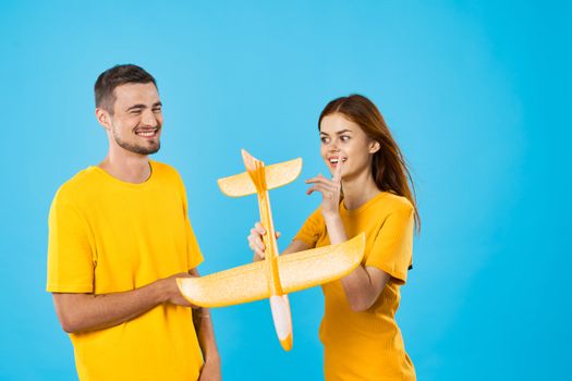 Married couple going on a trip and toy airplane in hand