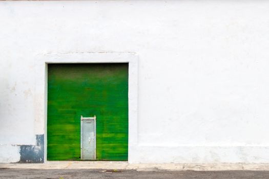 White wall background with metallic green curtain. copy space. urban background