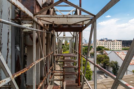 Pedestrian overpass in old factory. rusty metal, dangerous place. Metal structure