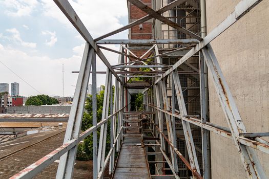 Pedestrian overpass in old factory. rusty metal, dangerous place. Metal structure