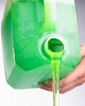 liquid soap in plastic bottle, pouring by hands