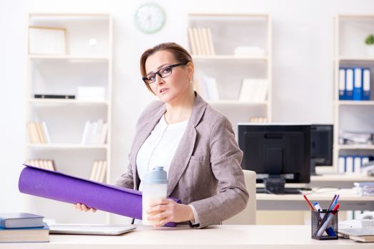 Woman employee going to sports from work during lunch break