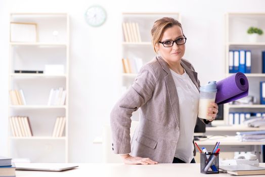 Woman employee going to sports from work during lunch break