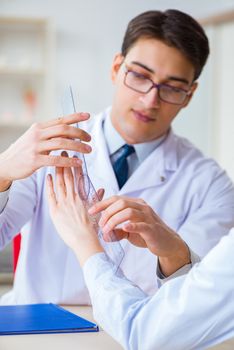 Doctor checking patients joint flexibility with gonimeter
