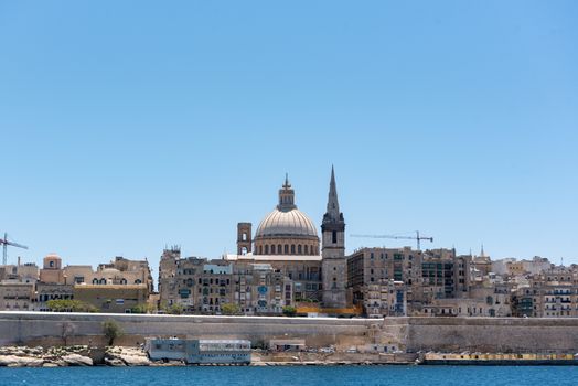 Beautiful Valletta skyline under blue sky, Valletta to Sliema Ferry, viewed from Manoel Island across Marsamxett Harbour. Valletta, Capital city of Malta, November 2019