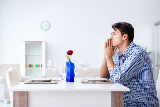 Man alone preparing for romantic date with his sweetheart