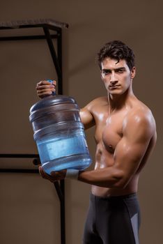 Muscular ripped man with big water bottle