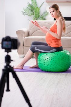 Pregnant woman recording video for blog and vlog
