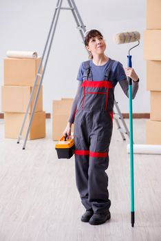 Woman painter painting in new apartment