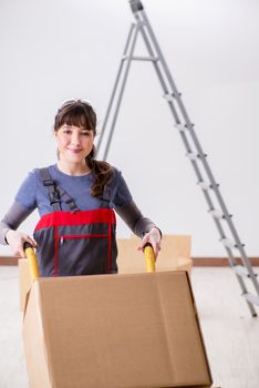 Woman contractor moving boxes in relocation concept