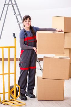 Woman contractor moving boxes in relocation concept