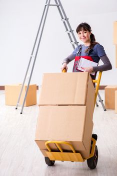Woman contractor moving boxes in relocation concept