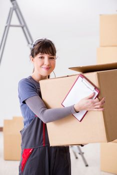 Woman contractor moving boxes in relocation concept
