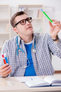 Young student studying chemistry in university