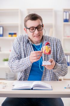 Medical student studying heart in classroom during lecture